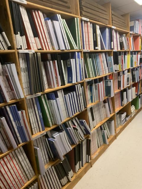 Rows of large-print textbooks, instructor books, & activity books sit on wood shelves at the Tennessee Instructional Resource Center.