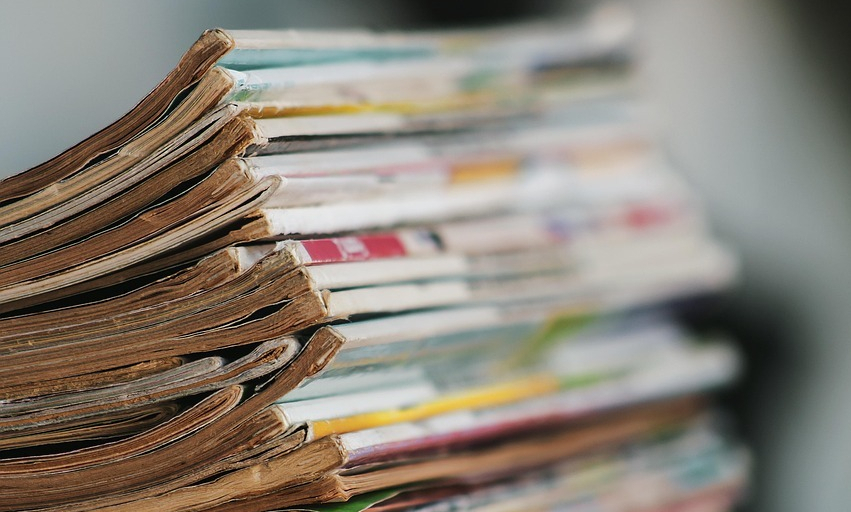 A stack of old catalogs photographed from the side.